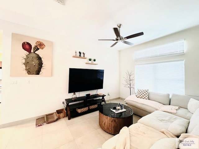 tiled living room featuring ceiling fan