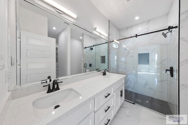 bathroom with vanity and a shower with shower door