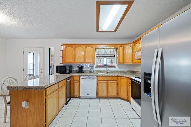 100 Pocahontas Dr Unit 100, Harlingen, TX 78552 - kitchen with stainless steel refrigerator with ice dispenser, dishwasher, black microwave, a peninsula, and a sink
