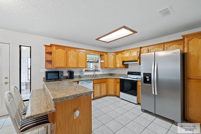 100 Pocahontas Dr Unit 100, Harlingen, TX 78552 - kitchen featuring stainless steel fridge, electric stove, black microwave, a peninsula, and open shelves