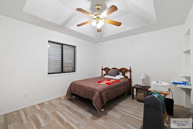 100 Pocahontas Dr Unit 100, Harlingen, TX 78552 - bedroom featuring light wood finished floors, a textured ceiling, ceiling fan, and baseboards