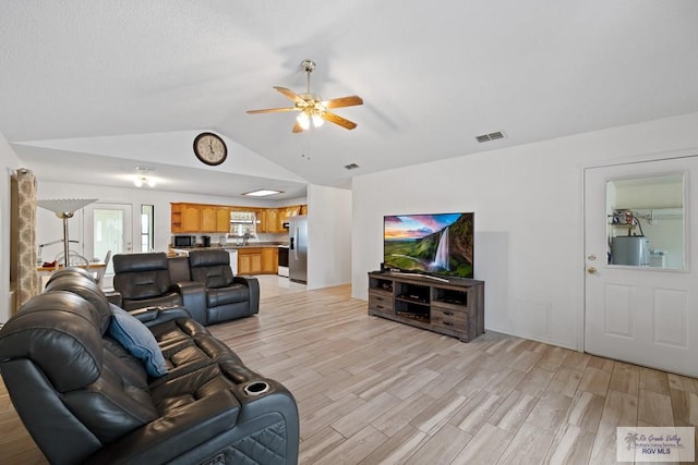 100 Pocahontas Dr Unit 100, Harlingen, TX 78552 - living room with a ceiling fan, light wood-type flooring, vaulted ceiling, and water heater
