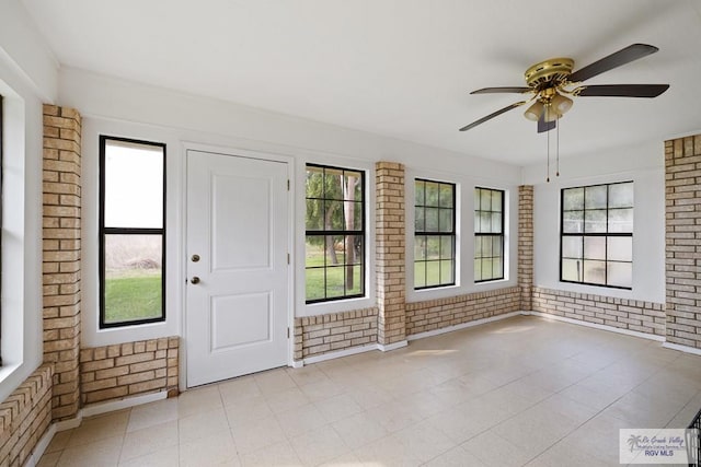 100 Pocahontas Dr Unit 100, Harlingen, TX 78552 - foyer entrance featuring brick wall and ceiling fan