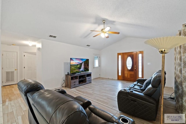 100 Pocahontas Dr Unit 100, Harlingen, TX 78552 - living area featuring ceiling fan, vaulted ceiling, light wood-style flooring, and a textured ceiling