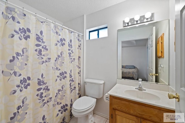 100 Pocahontas Dr Unit 100, Harlingen, TX 78552 - ensuite bathroom featuring vanity, toilet, a textured ceiling, a shower with shower curtain, and tile patterned flooring