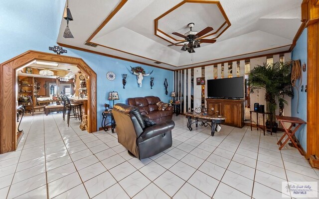 34390 Fm 732, San Benito, TX 78586 - living room with visible vents, ornamental molding, light tile patterned floors, a raised ceiling, and a ceiling fan