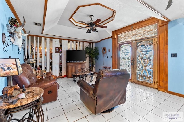 34390 Fm 732, San Benito, TX 78586 - living area featuring visible vents, french doors, light tile patterned flooring, a raised ceiling, and a ceiling fan