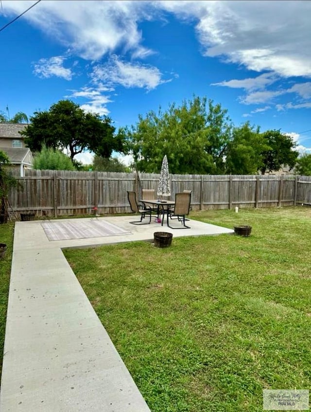 view of yard featuring a patio area and a fenced backyard