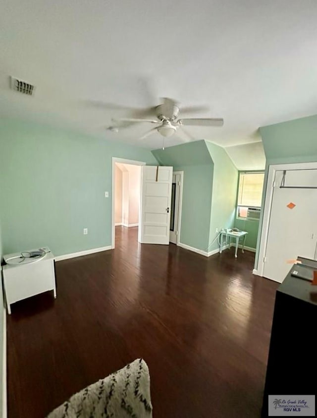 unfurnished bedroom with ceiling fan, visible vents, baseboards, and dark wood-style floors