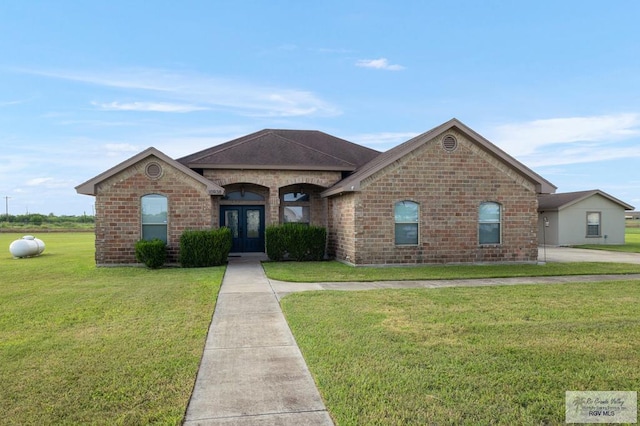 ranch-style home featuring a front lawn and french doors