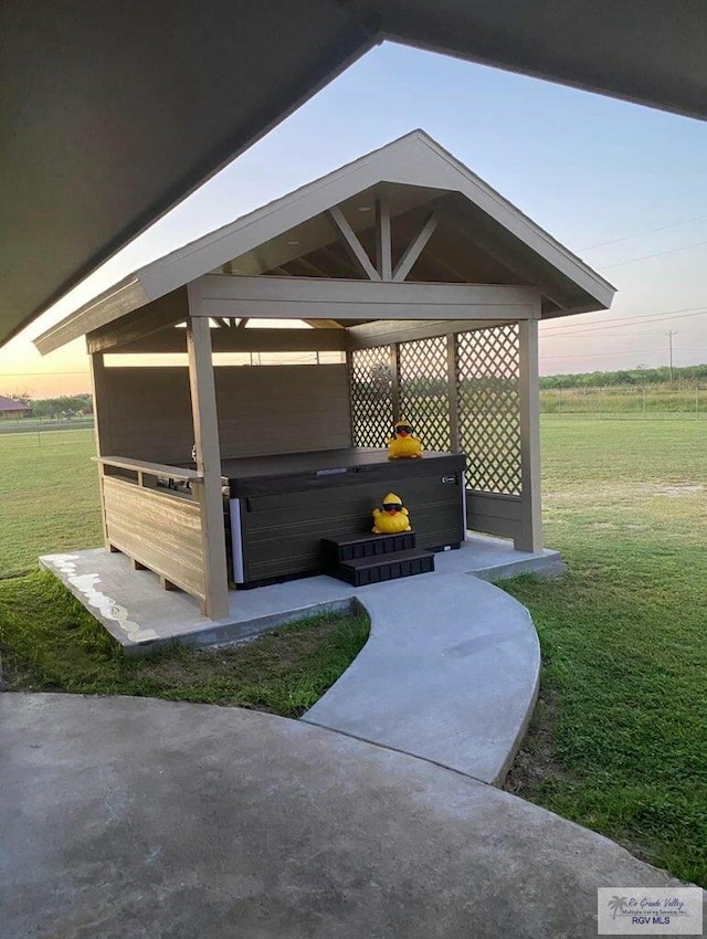 patio terrace at dusk with a yard and a rural view