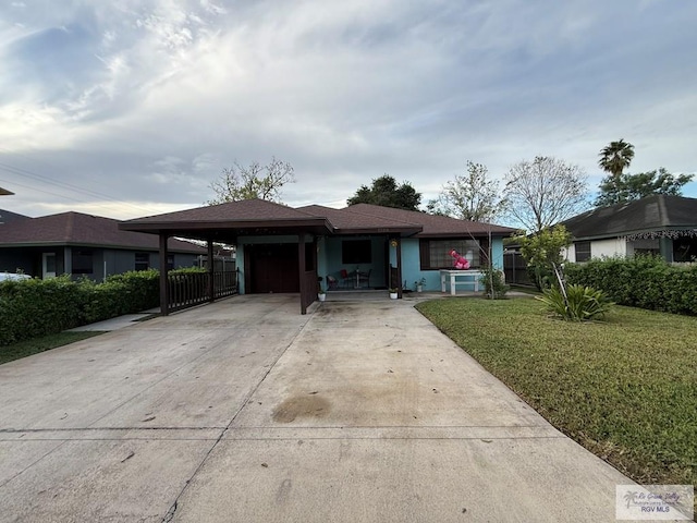 ranch-style home featuring a carport and a front yard