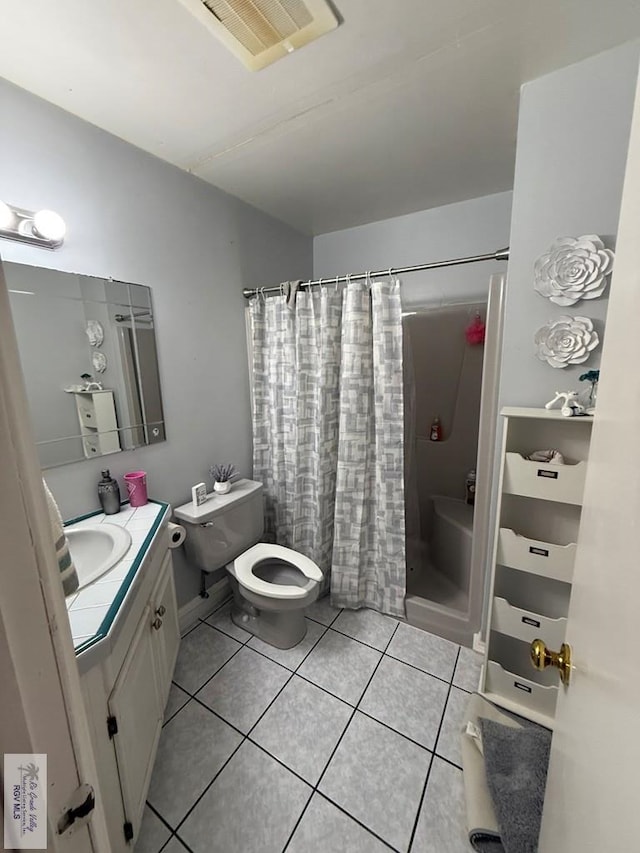 bathroom with a shower with shower curtain, vanity, tile patterned flooring, and toilet