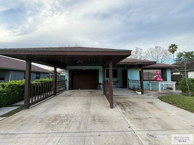 view of front of property with a garage and a carport