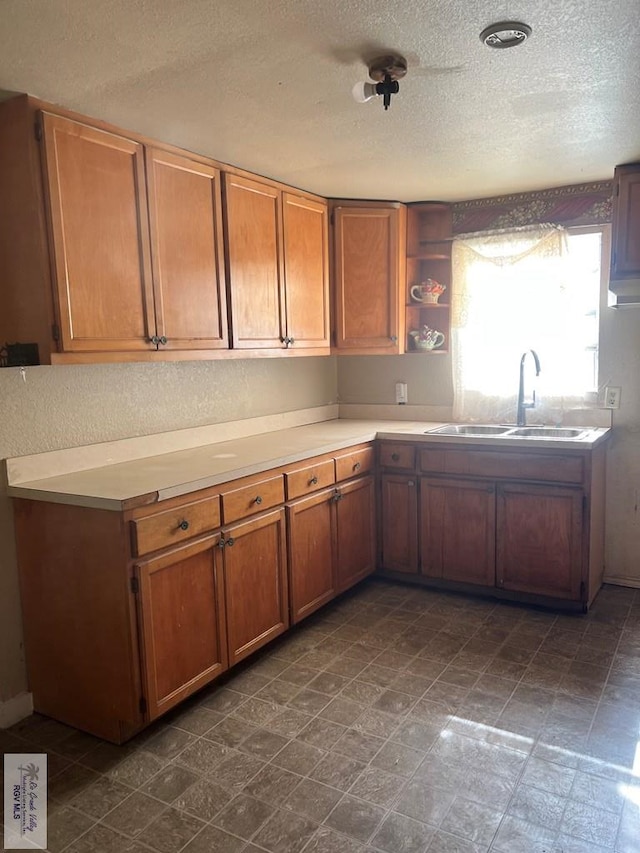 kitchen featuring sink and a textured ceiling