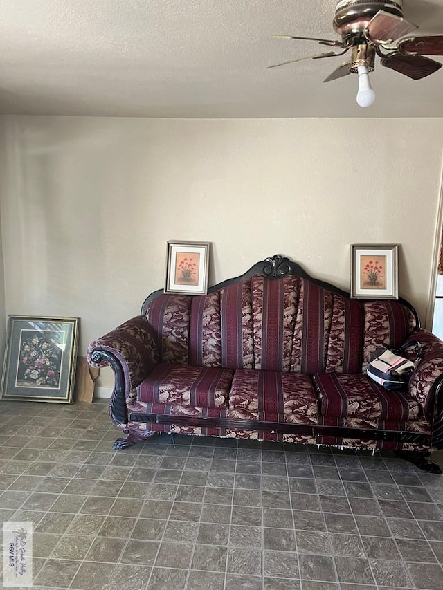 living room featuring a textured ceiling and ceiling fan