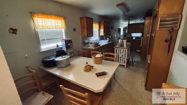 1330 Reagan St Unit 3, San Benito, TX 78586 - kitchen with a peninsula, light countertops, and a breakfast bar area