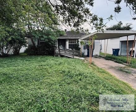 1330 Reagan St Unit 3, San Benito, TX 78586 - view of front of property with a front yard and driveway