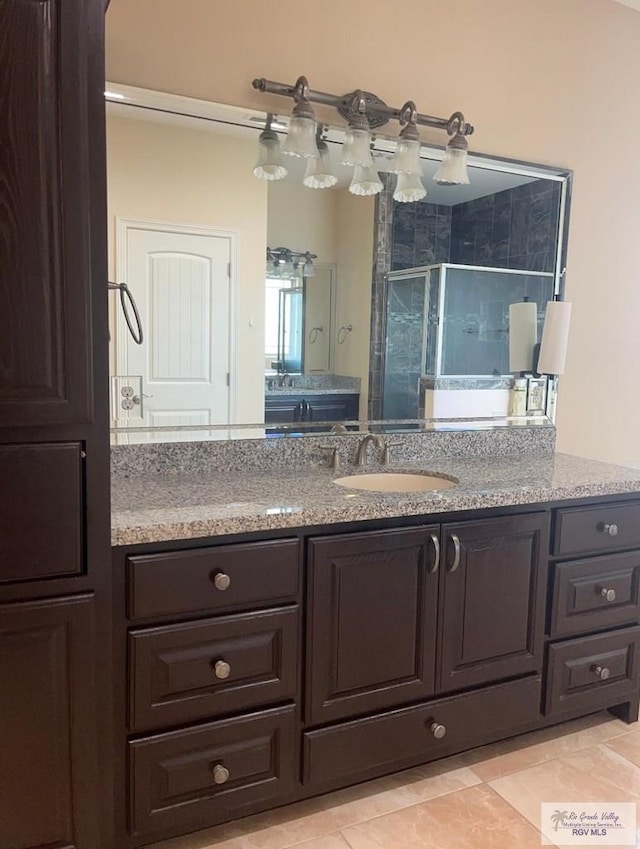 bathroom with vanity, tile patterned floors, and a shower with shower door