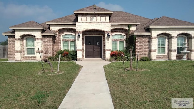 french provincial home with a front lawn