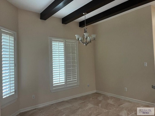 empty room featuring beam ceiling and a notable chandelier