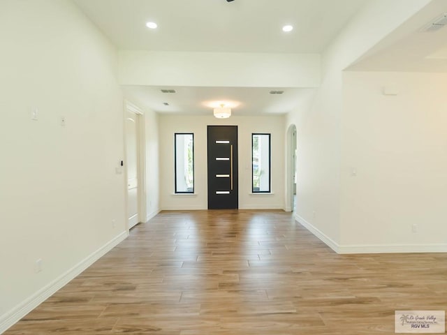 23100 Hidalgo Ave, Harlingen, TX 78552 - entryway featuring light wood finished floors, arched walkways, baseboards, and recessed lighting