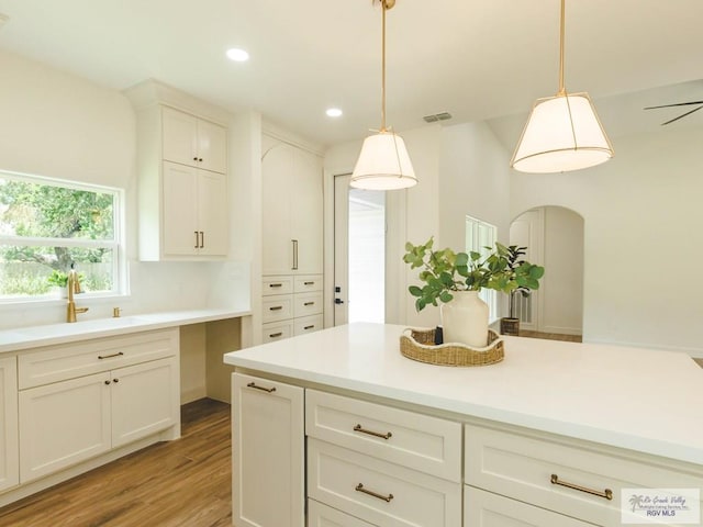 23100 Hidalgo Ave, Harlingen, TX 78552 - kitchen with light wood-type flooring, decorative light fixtures, light countertops, and recessed lighting