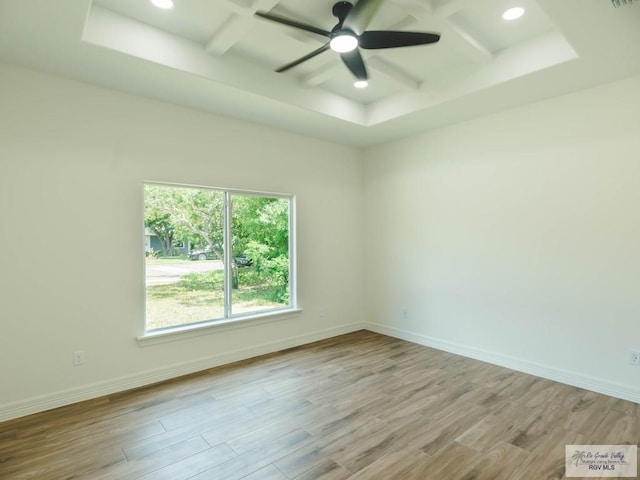 23100 Hidalgo Ave, Harlingen, TX 78552 - empty room with coffered ceiling, wood finished floors, ceiling fan, beam ceiling, and baseboards