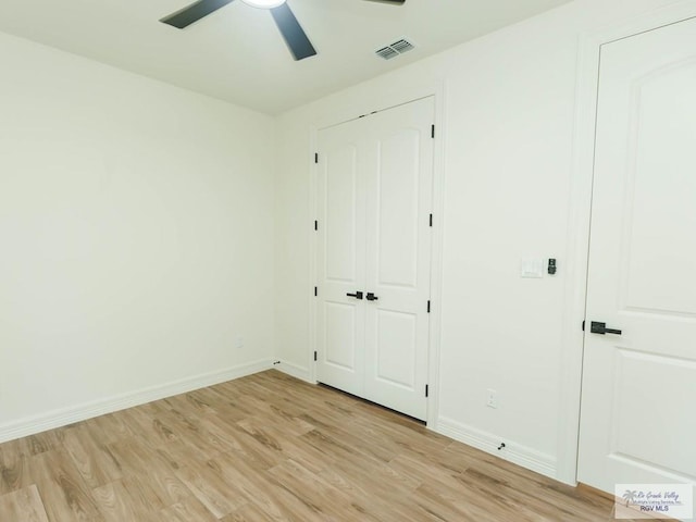 23100 Hidalgo Ave, Harlingen, TX 78552 - unfurnished bedroom featuring light wood-style floors, baseboards, a ceiling fan, and a closet