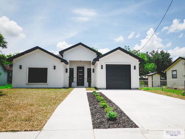 23100 Hidalgo Ave, Harlingen, TX 78552 - view of front facade featuring concrete driveway, a garage, and stucco siding
