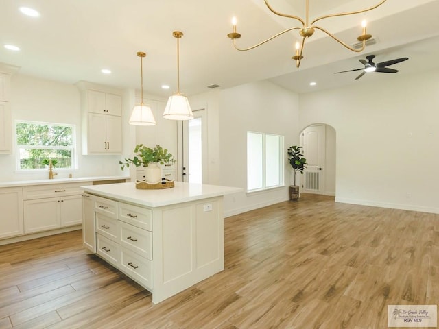 23100 Hidalgo Ave, Harlingen, TX 78552 - kitchen featuring light wood-style flooring, light countertops, open floor plan, recessed lighting, and a center island