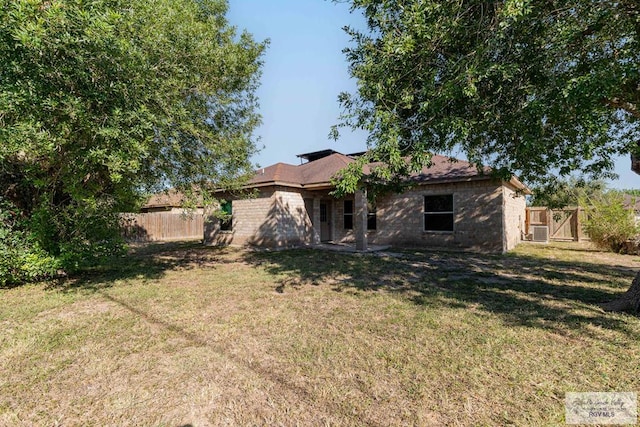 rear view of property with a lawn