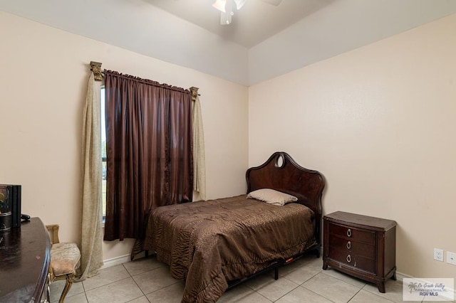 tiled bedroom featuring ceiling fan