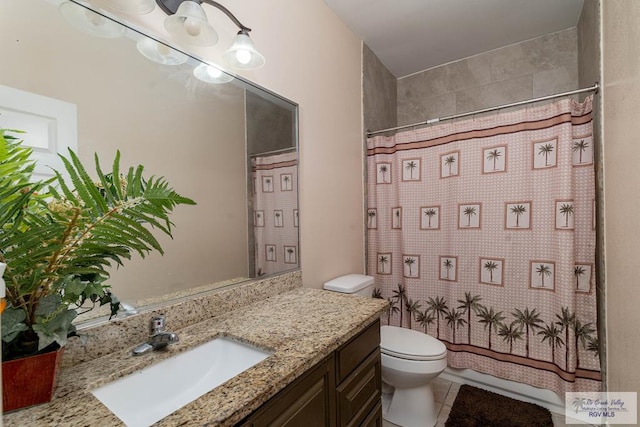 bathroom featuring tile patterned flooring, vanity, and toilet