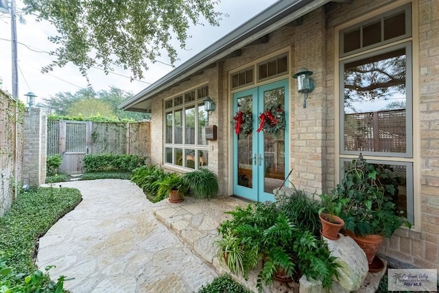 view of exterior entry featuring a patio and french doors