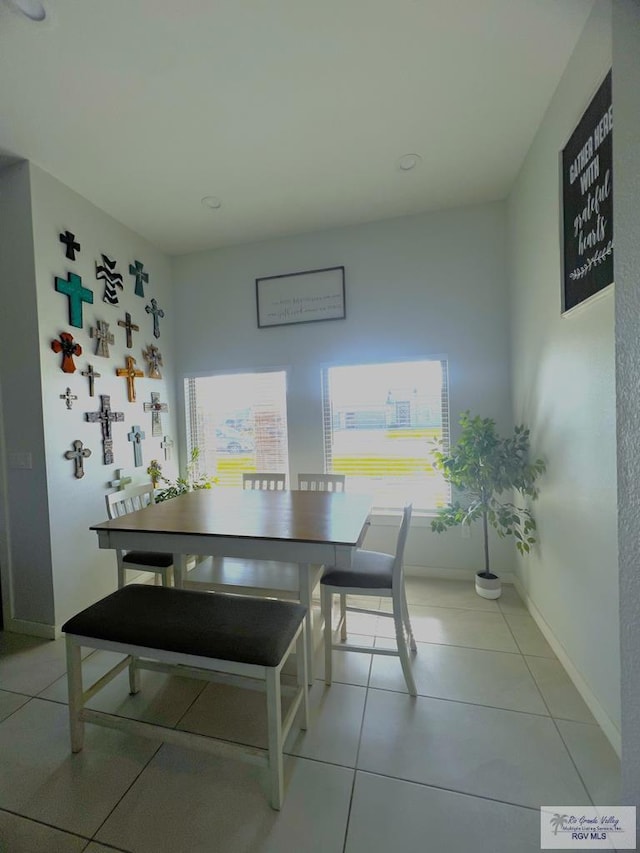 dining space featuring light tile patterned flooring