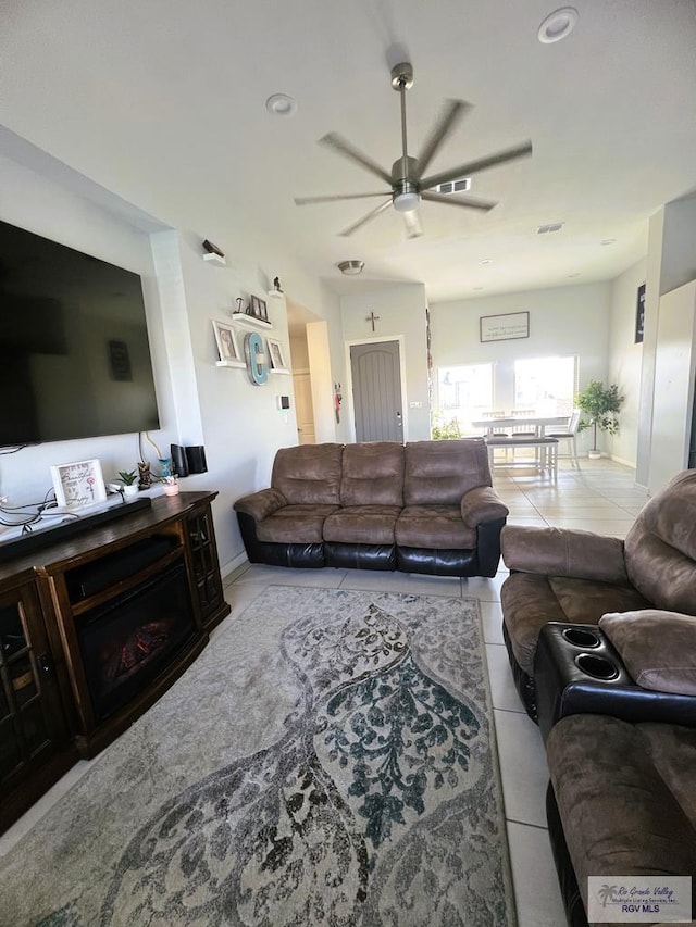 tiled living room featuring ceiling fan