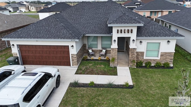 view of front of house with a front yard and a garage