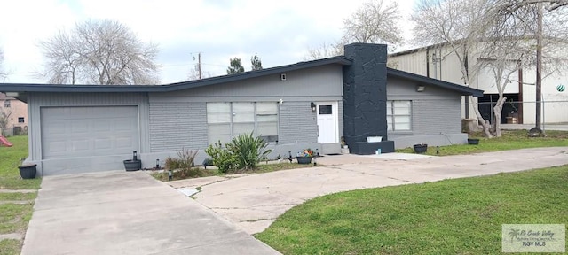 view of front of property with a garage and a front lawn