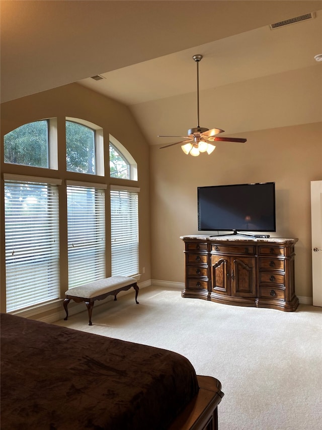 bedroom featuring ceiling fan, light colored carpet, and lofted ceiling