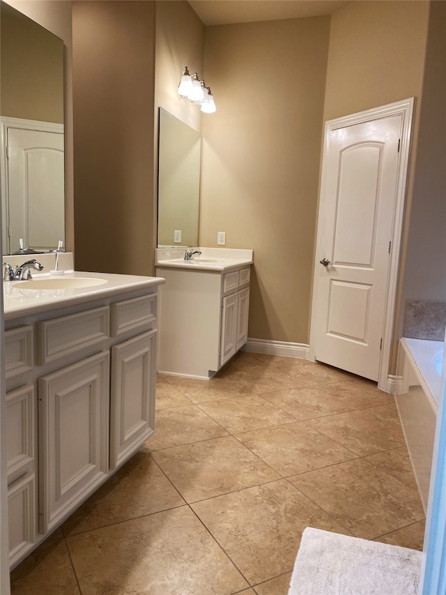 bathroom featuring vanity, a bath, and tile patterned floors