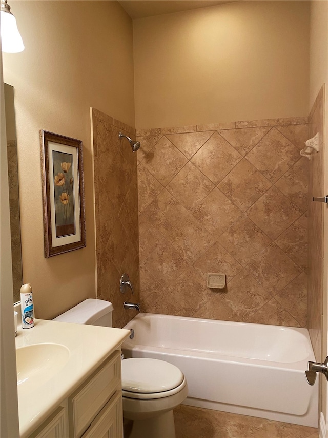 full bathroom with vanity, tiled shower / bath, and toilet