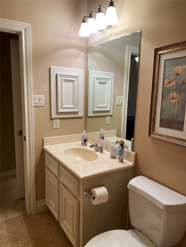 bathroom with tile patterned floors, vanity, and toilet