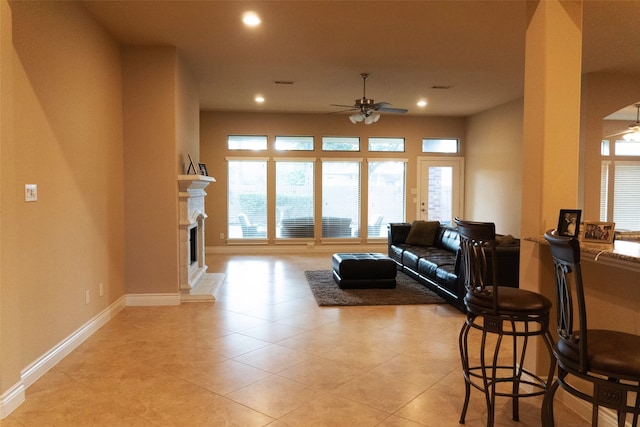 tiled living room with ceiling fan