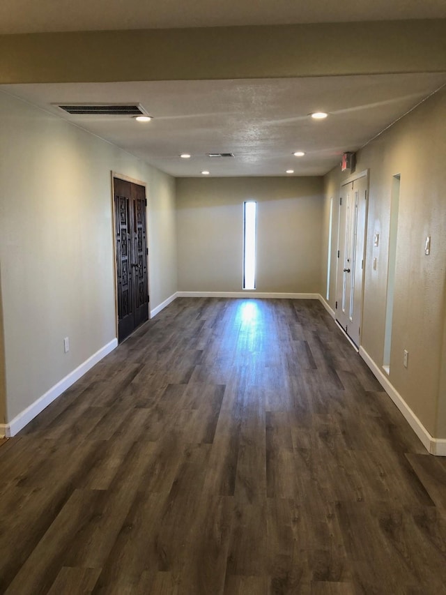 spare room with dark hardwood / wood-style flooring