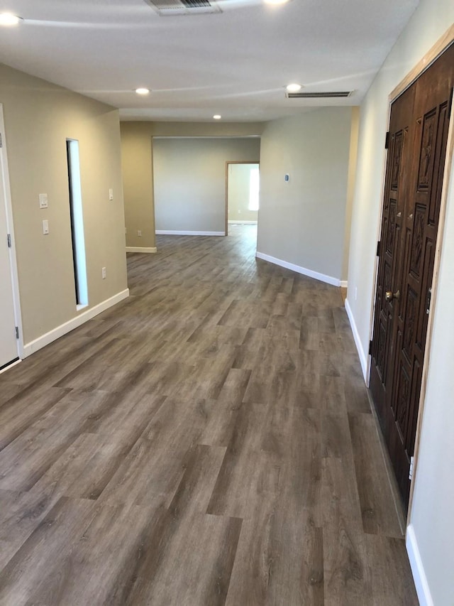 spare room featuring dark wood-type flooring