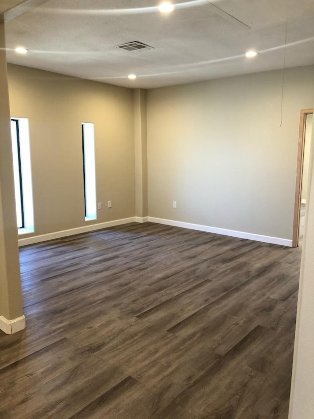 empty room featuring dark wood-type flooring