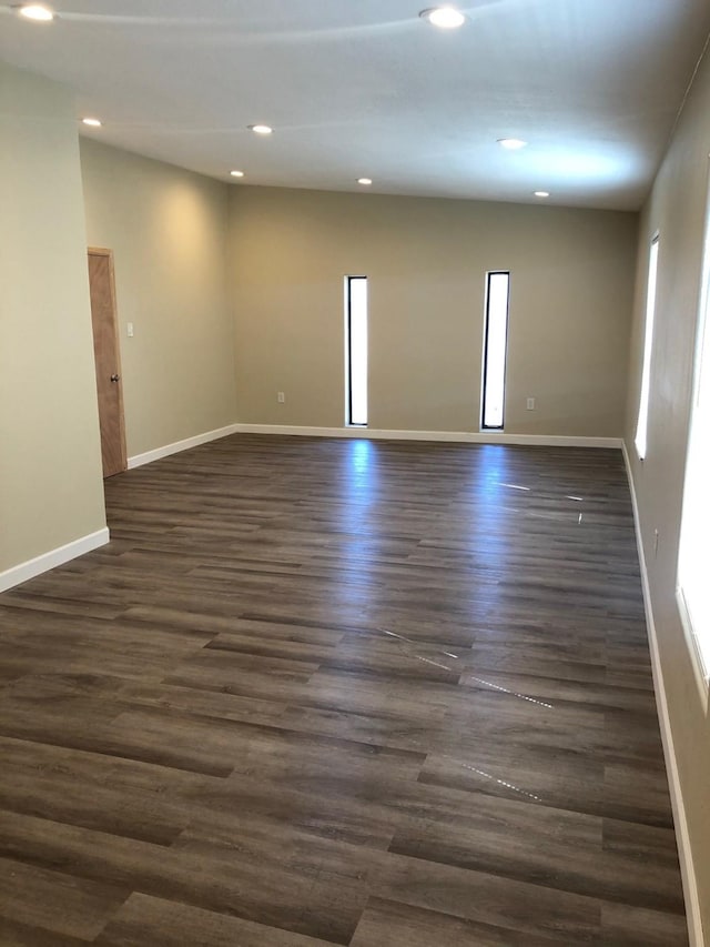 spare room featuring dark wood-type flooring