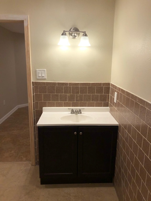 bathroom with tile walls, tasteful backsplash, tile floors, and vanity