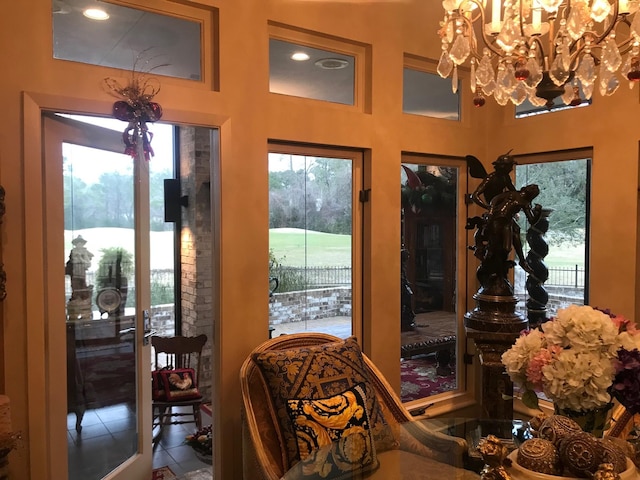 doorway featuring tile patterned flooring and a notable chandelier